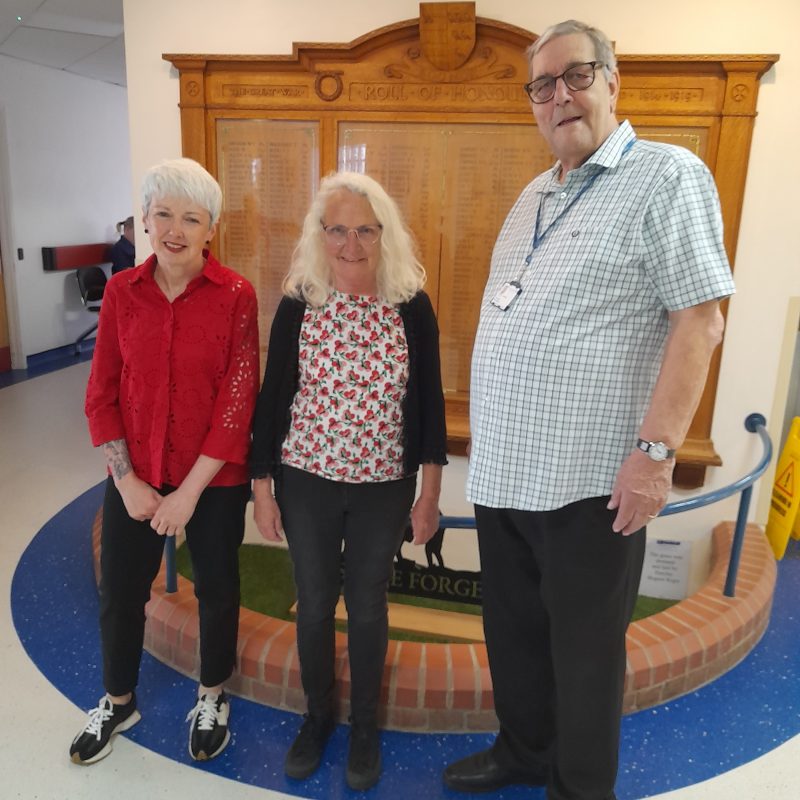Chairman Brian Knight receives a cheque from Hilary and Paula of MusicSmart in front of the War Memorial at Bognor Hospital