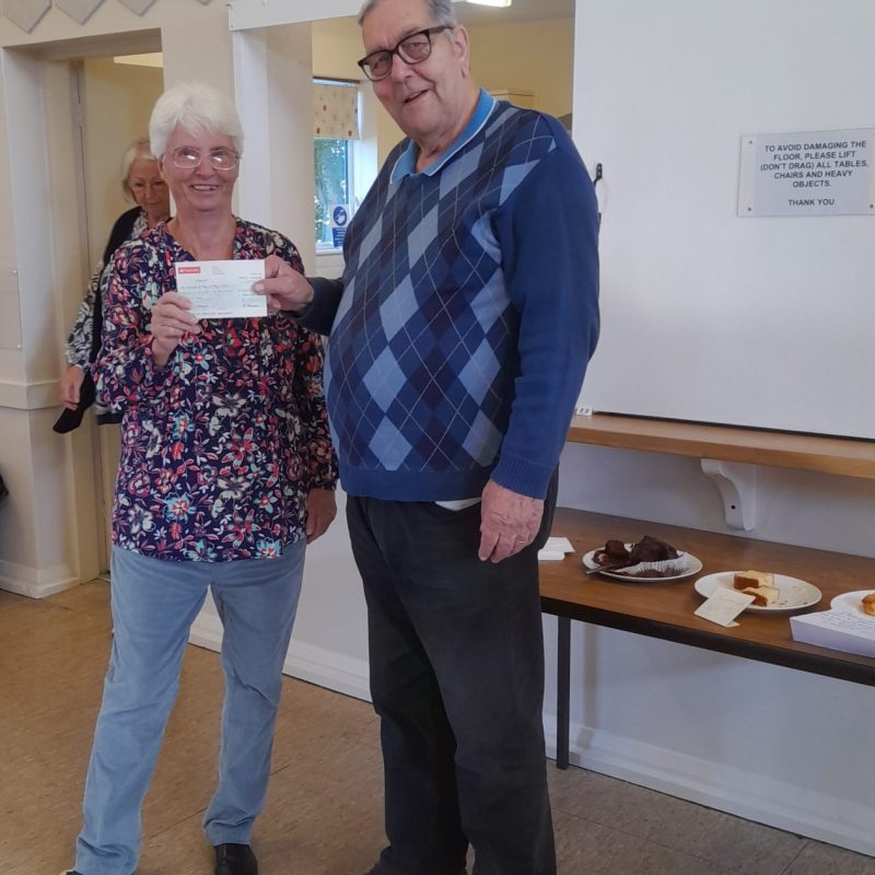 Chairman Brian Knight is presented with a cheque by Mrs Liz Nicholls in the West Meads Community Centre