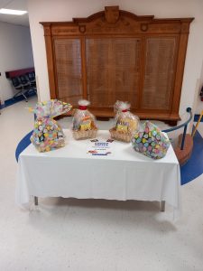 In front of the war memorial there is a table of four Easter themed hampers as raffle prizes 