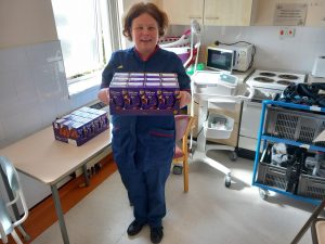 A staff member holding Easter Eggs for the wards